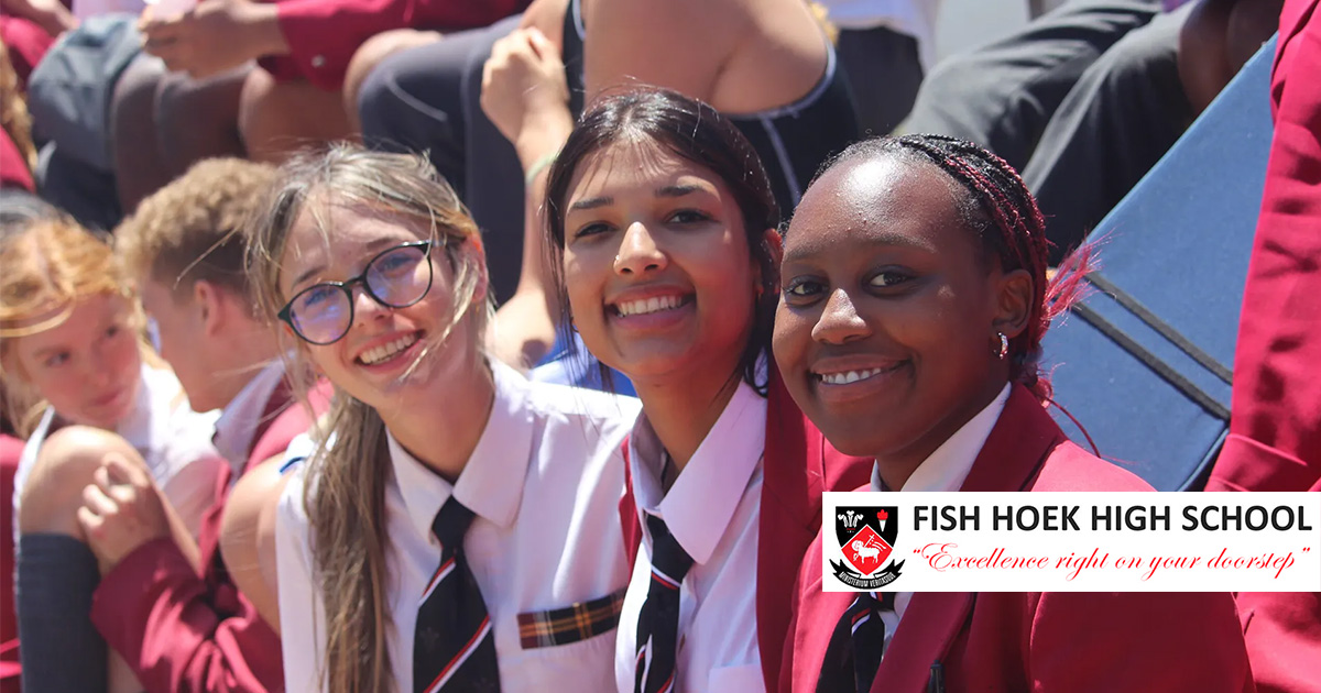 Sunlit school grounds at Fish Hoek High School with learners in uniform walking between buildings on a clear Cape Town morning